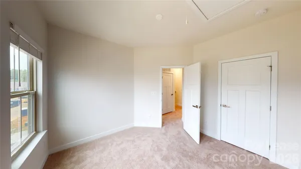 an empty room with windows and closet