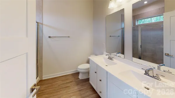 a bathroom with a sink and mirror with toilet