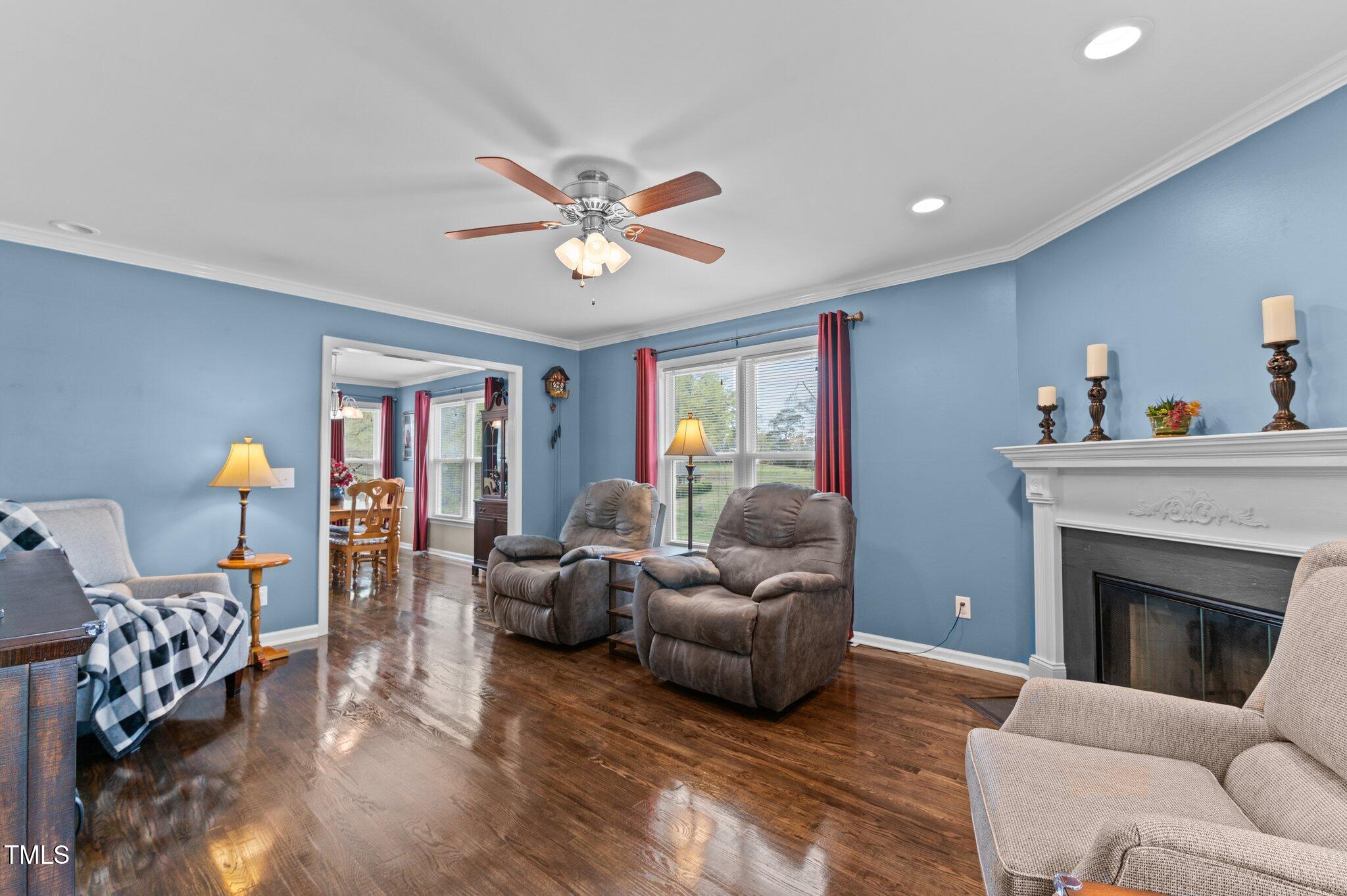 4810 Mitchell Mill Road Wake Forest, NC 27587 - Photo 10 of 35 a living room with furniture a fireplace and a chandelier