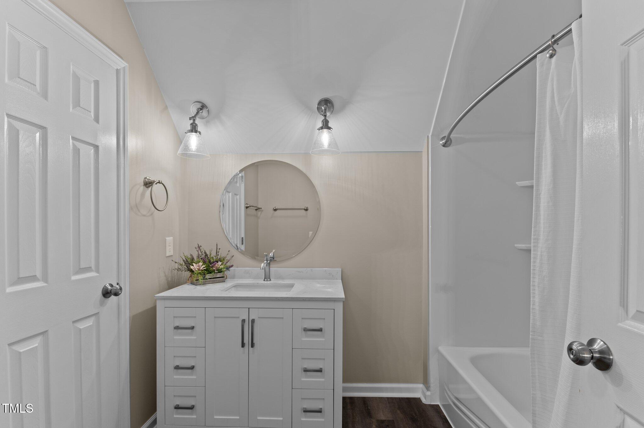 4810 Mitchell Mill Road Wake Forest, NC 27587 - Photo 22 of 35 a bathroom with a shower sink and mirror