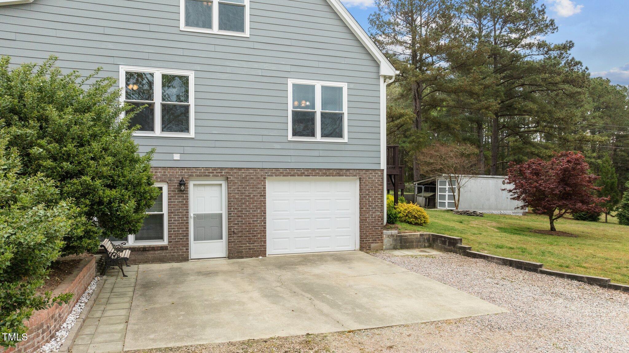 4810 Mitchell Mill Road Wake Forest, NC 27587 - Photo 32 of 35 a front view of a house with a yard and garage