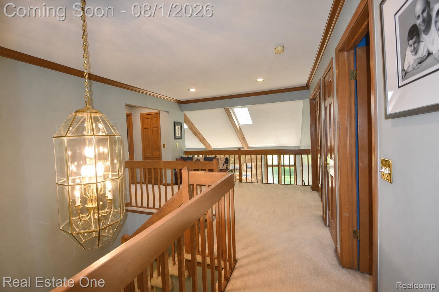 1370 Springwood Lane Rochester, MI 48309 - Photo 30 of 37 Upper-level hallway featuring a hanging glass and brass chandelier