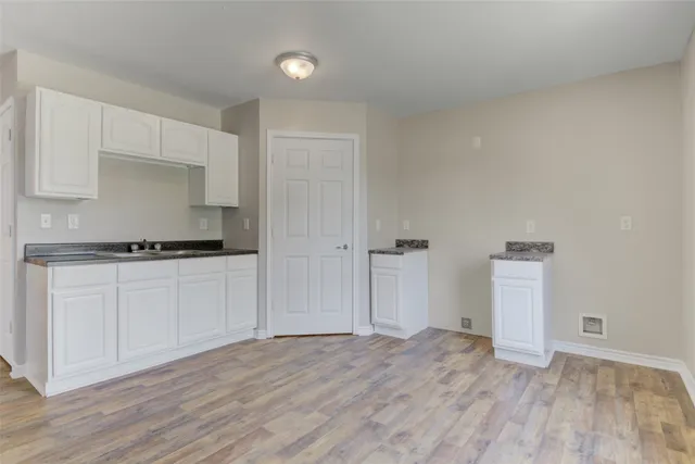 a view of a kitchen with a sink and a stove top oven