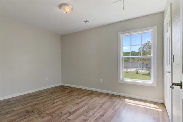 a view of an empty room and wooden floor