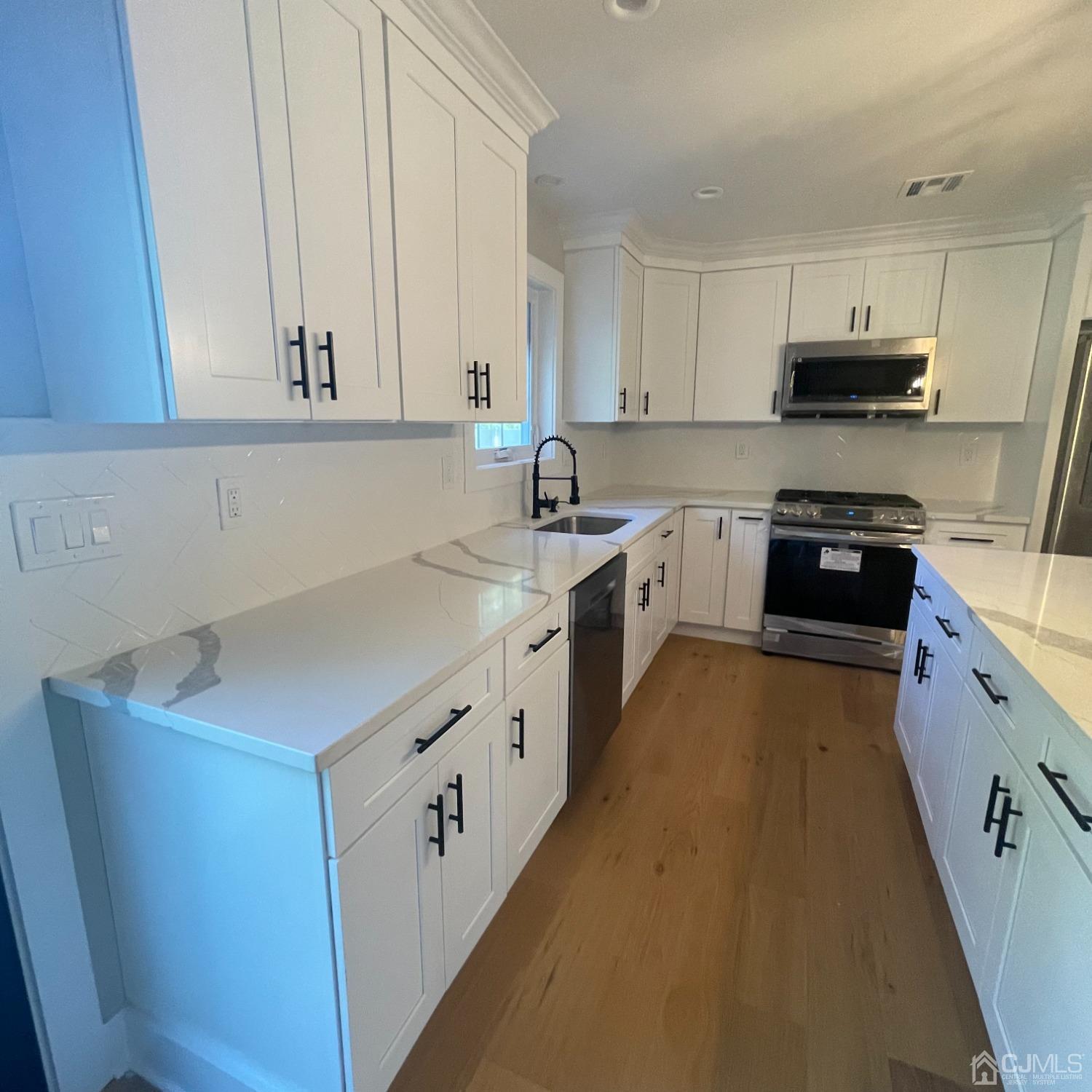 799 Highway 34 Matawan, NJ 07747 - Photo 2 of 11 a kitchen with granite countertop white cabinets and white appliances