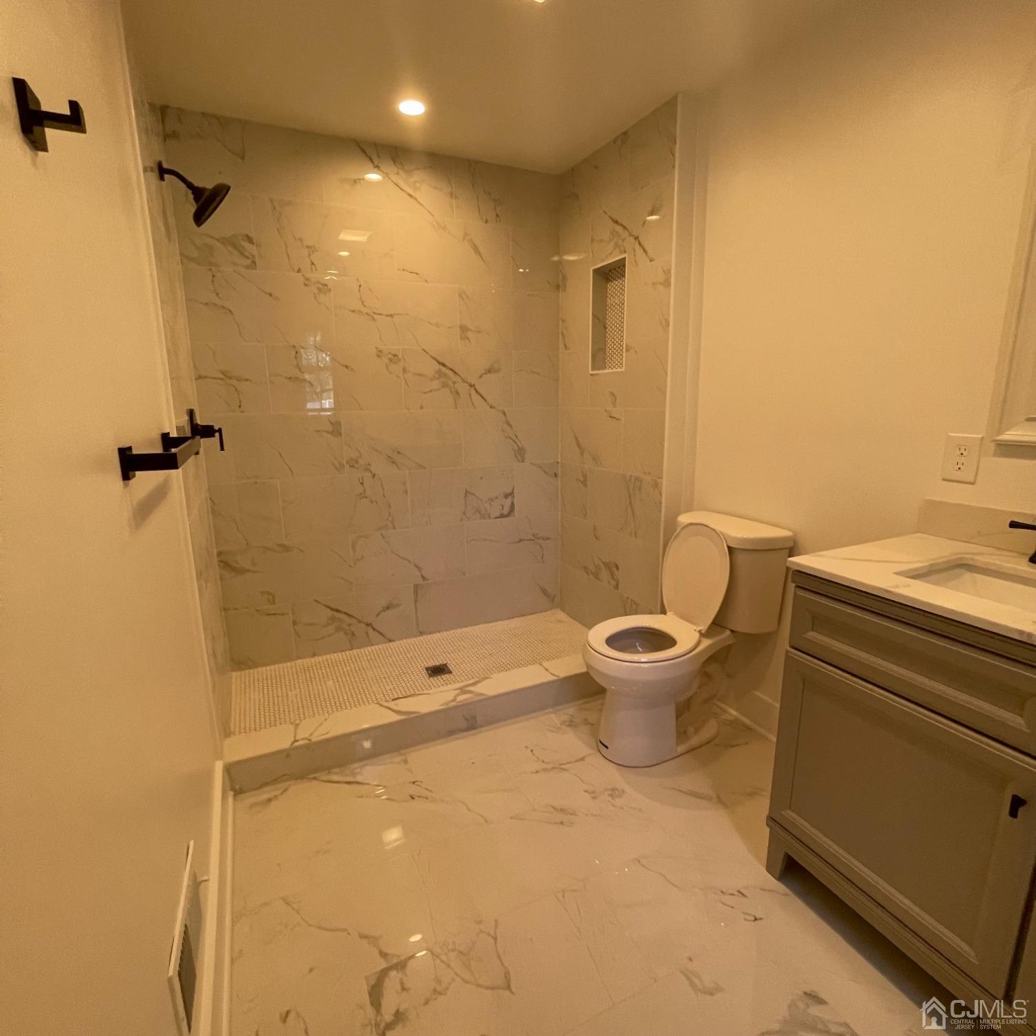 799 Highway 34 Matawan, NJ 07747 - Photo 10 of 11 a bathroom with a granite countertop toilet a sink and shower