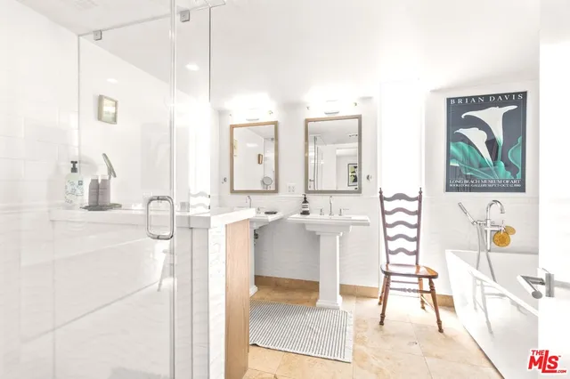 a bedroom with a bed a table and chair