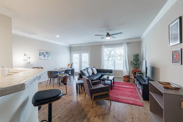 a living room with furniture and a wooden floor
