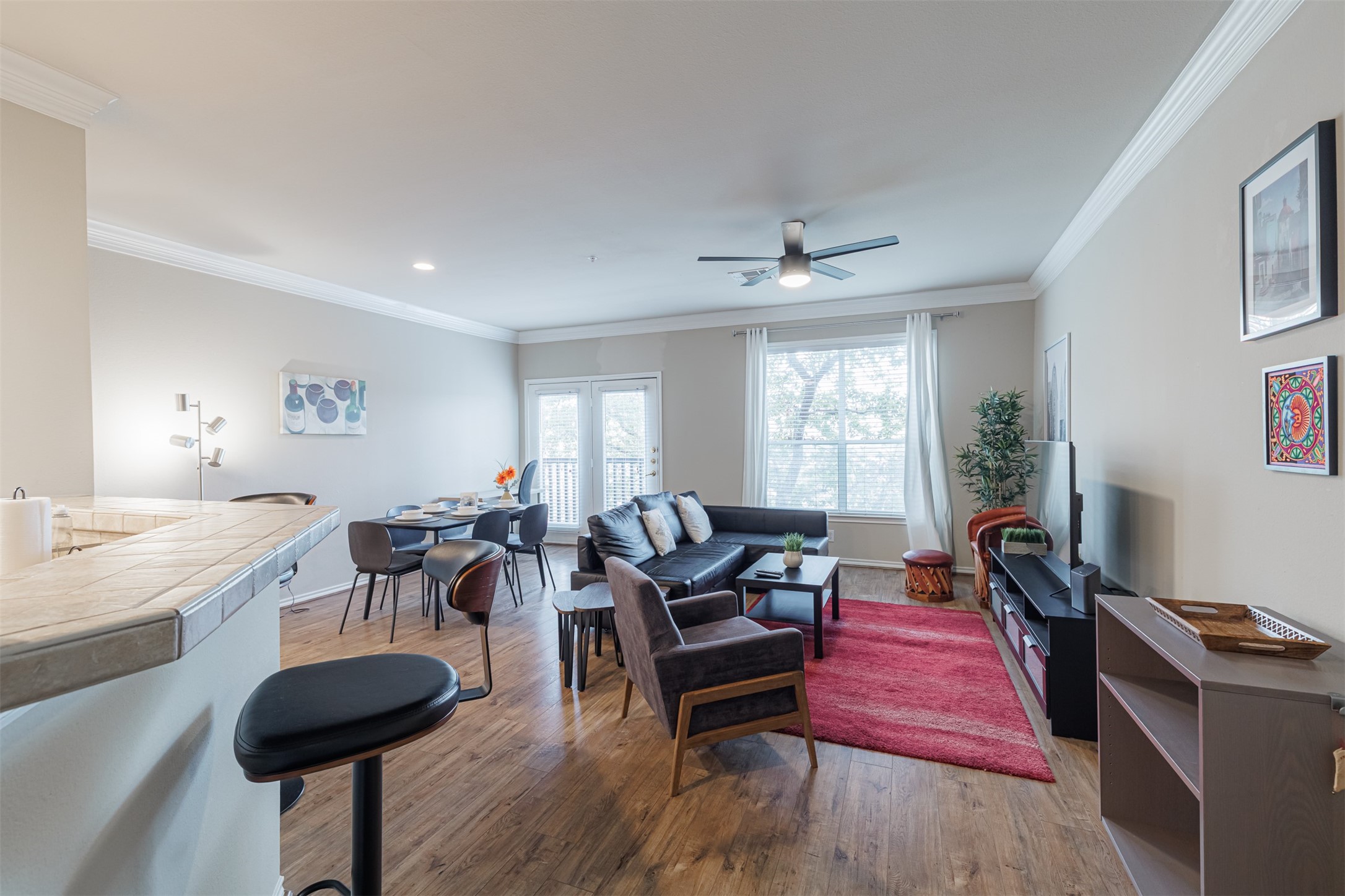 a living room with furniture and a wooden floor