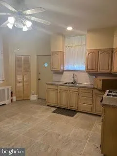 a kitchen with cabinets and window