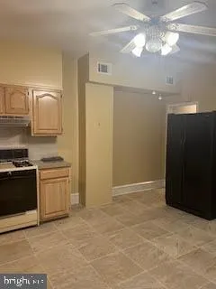 a kitchen with kitchen island cabinets and stainless steel appliances