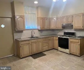 a kitchen with stainless steel appliances granite countertop a sink and cabinets
