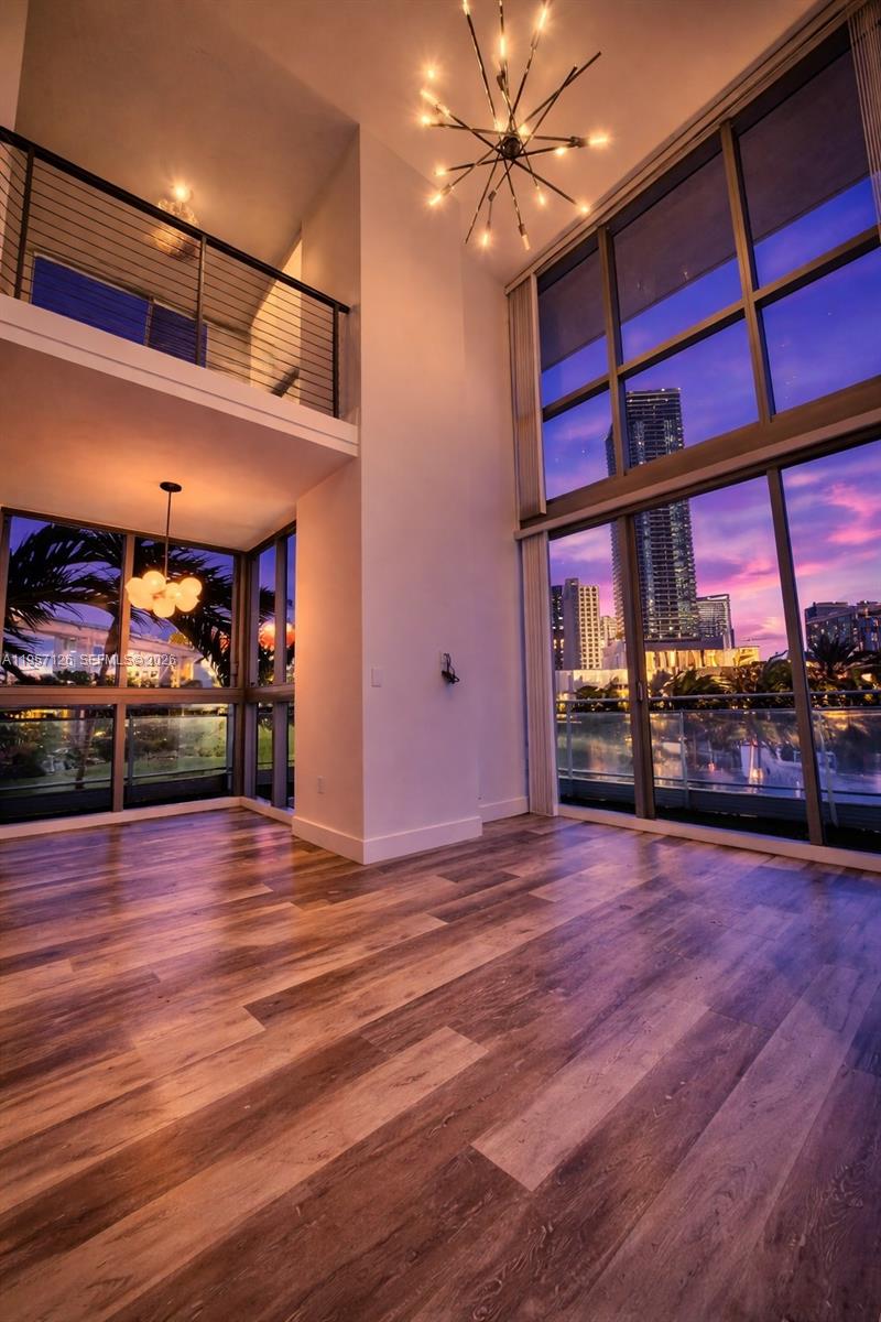 a view of a room with wooden floor