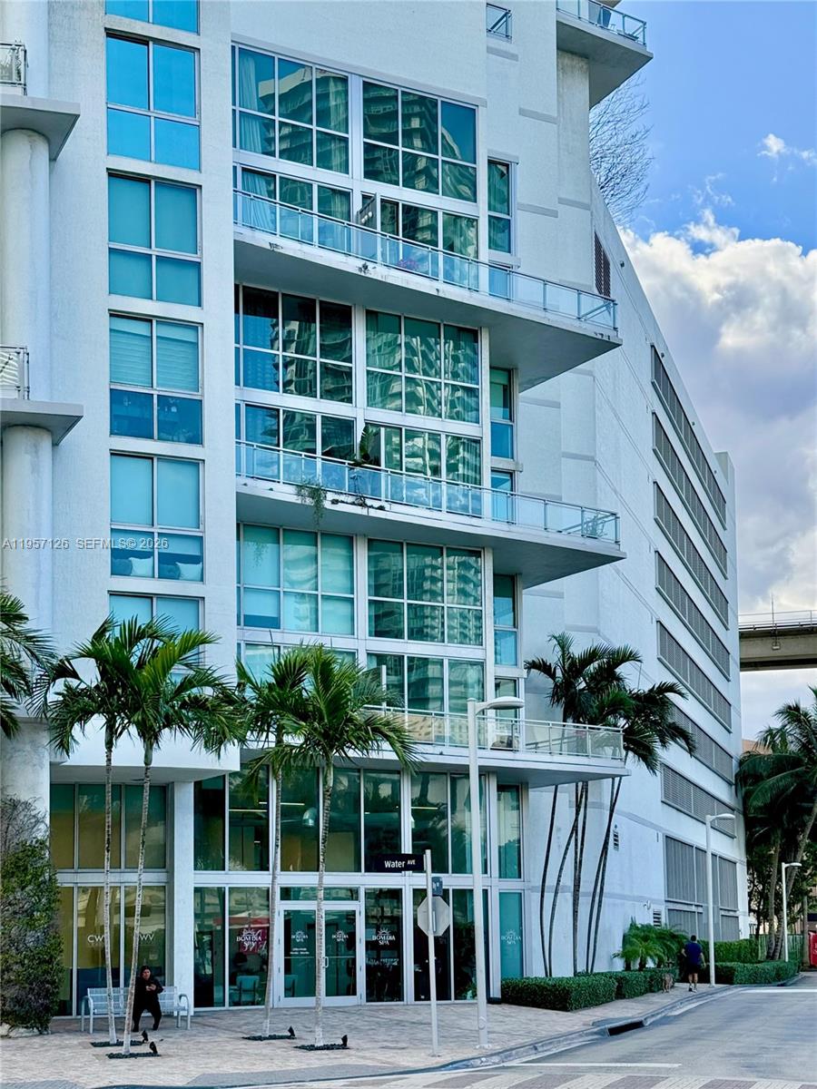 a front view of a building with a garden
