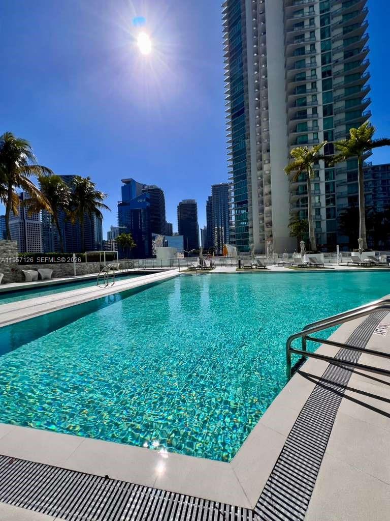 90 Southwest 3rd Street, Unit TH300A Miami, FL 33130 - Photo 18 of 21 a swimming pool with outdoor seating and yard