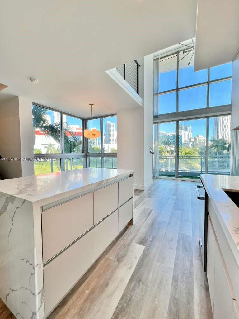 90 Southwest 3rd Street, Unit TH300A Miami, FL 33130 - Photo 3 of 21 view of room with window and wooden floor