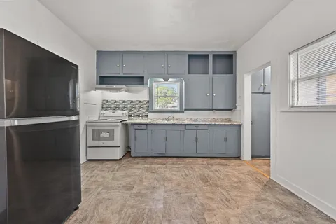 a kitchen with stainless steel appliances a refrigerator and a stove
