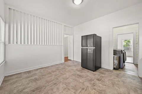 a view of an empty room with a kitchen