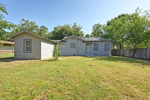 a view of a house with a yard and garage