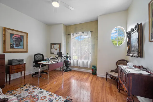 a view of a workspace with furniture and a window