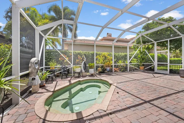 a room with lots of green walls and glass windows