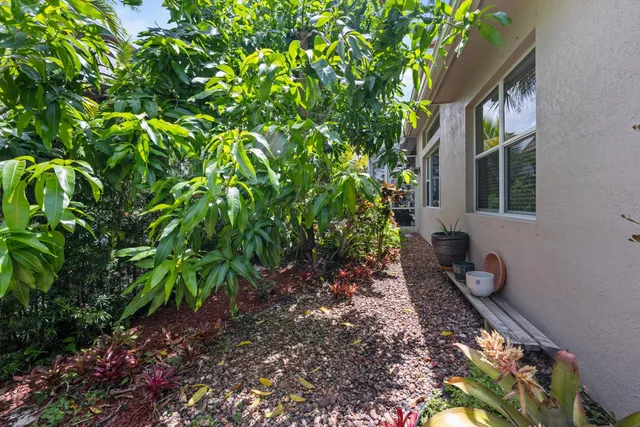 a front view of a house with a yard and fountain in middle