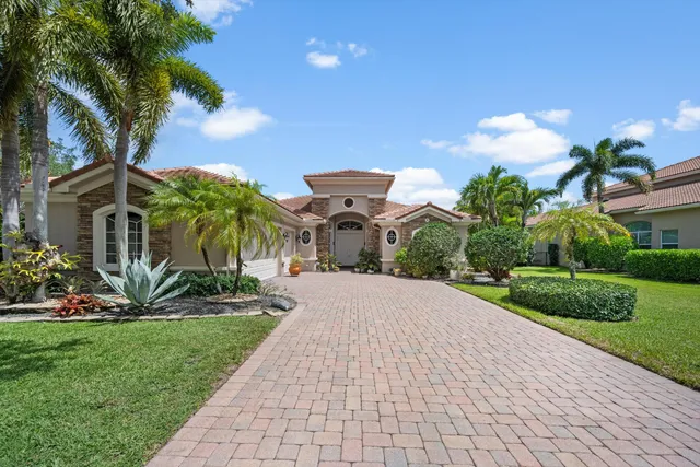a front view of a house with a yard and a garage