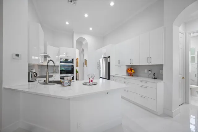 a kitchen with stainless steel appliances white cabinets and a sink