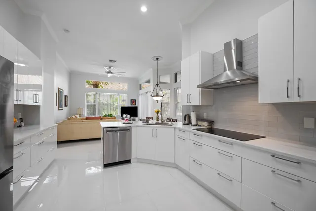 a kitchen with a sink a stove and cabinets