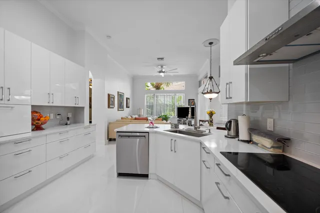 a kitchen with stainless steel appliances granite countertop a sink refrigerator and cabinets
