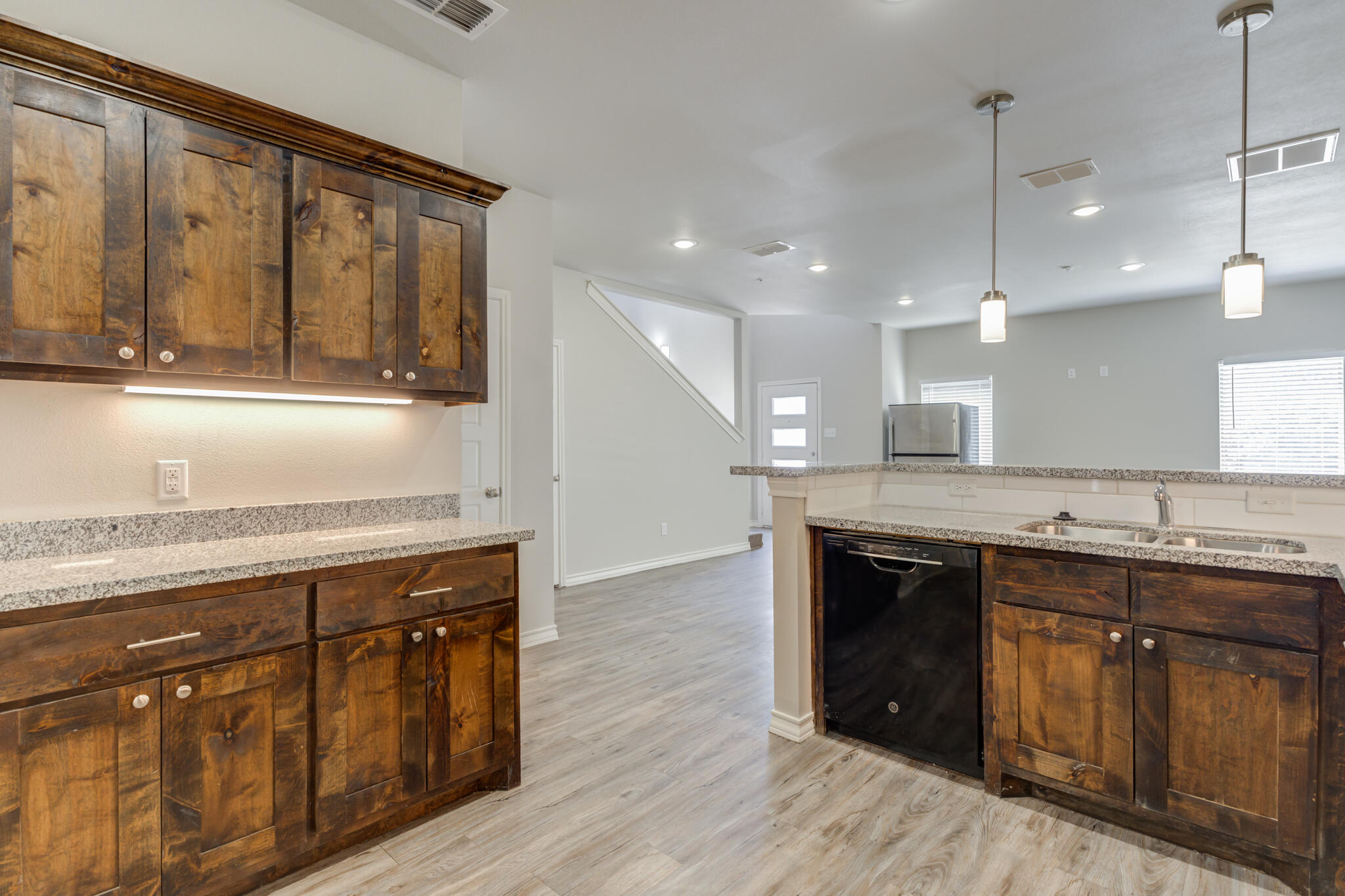3404 25th Street Lubbock, TX 79410 - Photo 12 of 38 a kitchen with a sink and a wooden floor