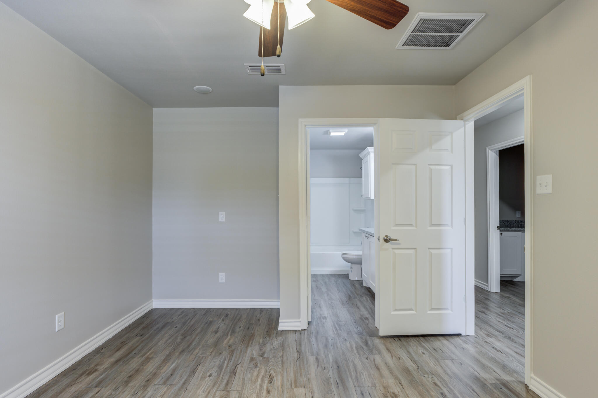 3404 25th Street Lubbock, TX 79410 - Photo 15 of 38 wooden floor in an empty room with a window