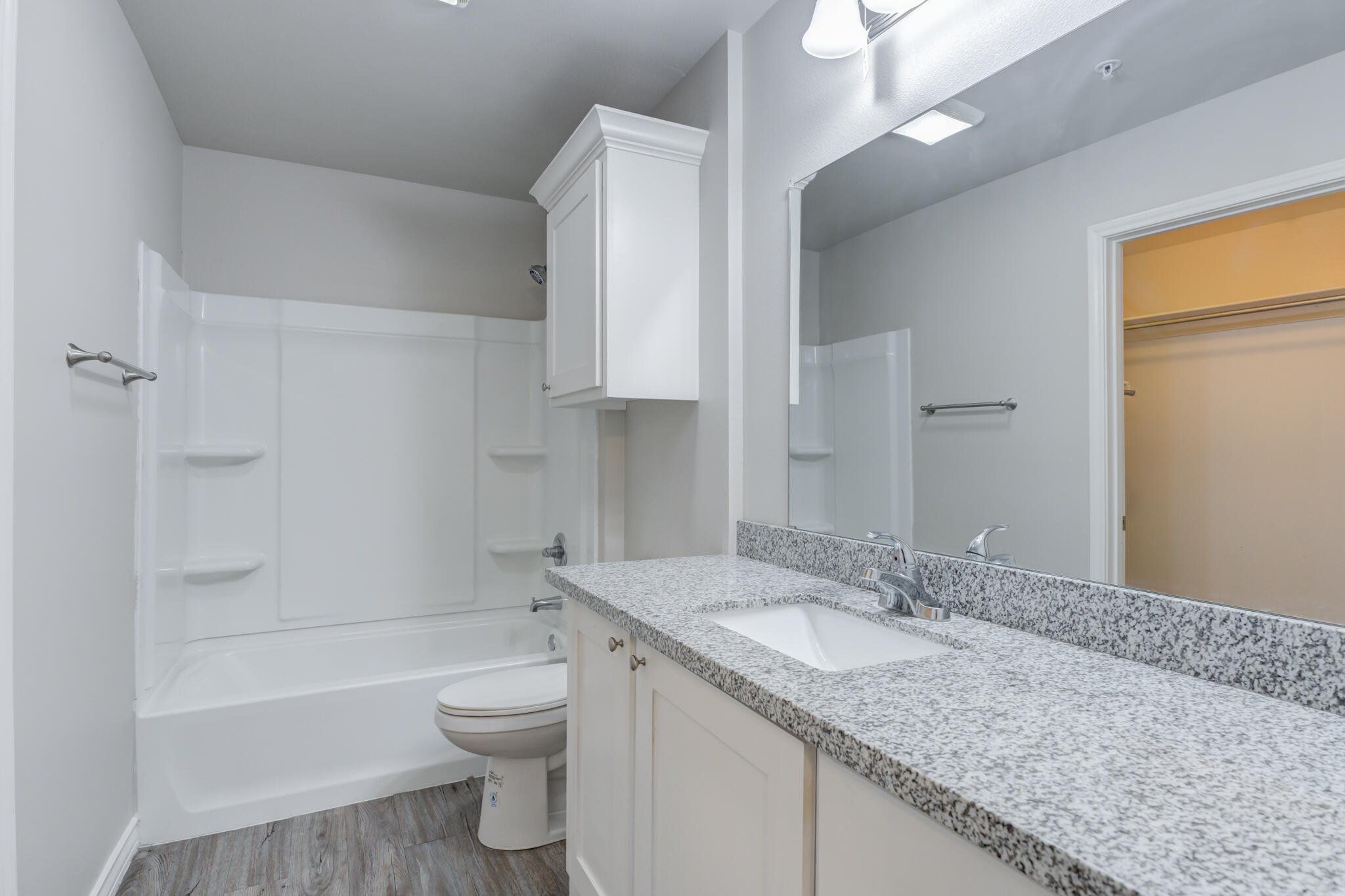 3404 25th Street Lubbock, TX 79410 - Photo 16 of 38 a bathroom with a granite countertop sink toilet and shower