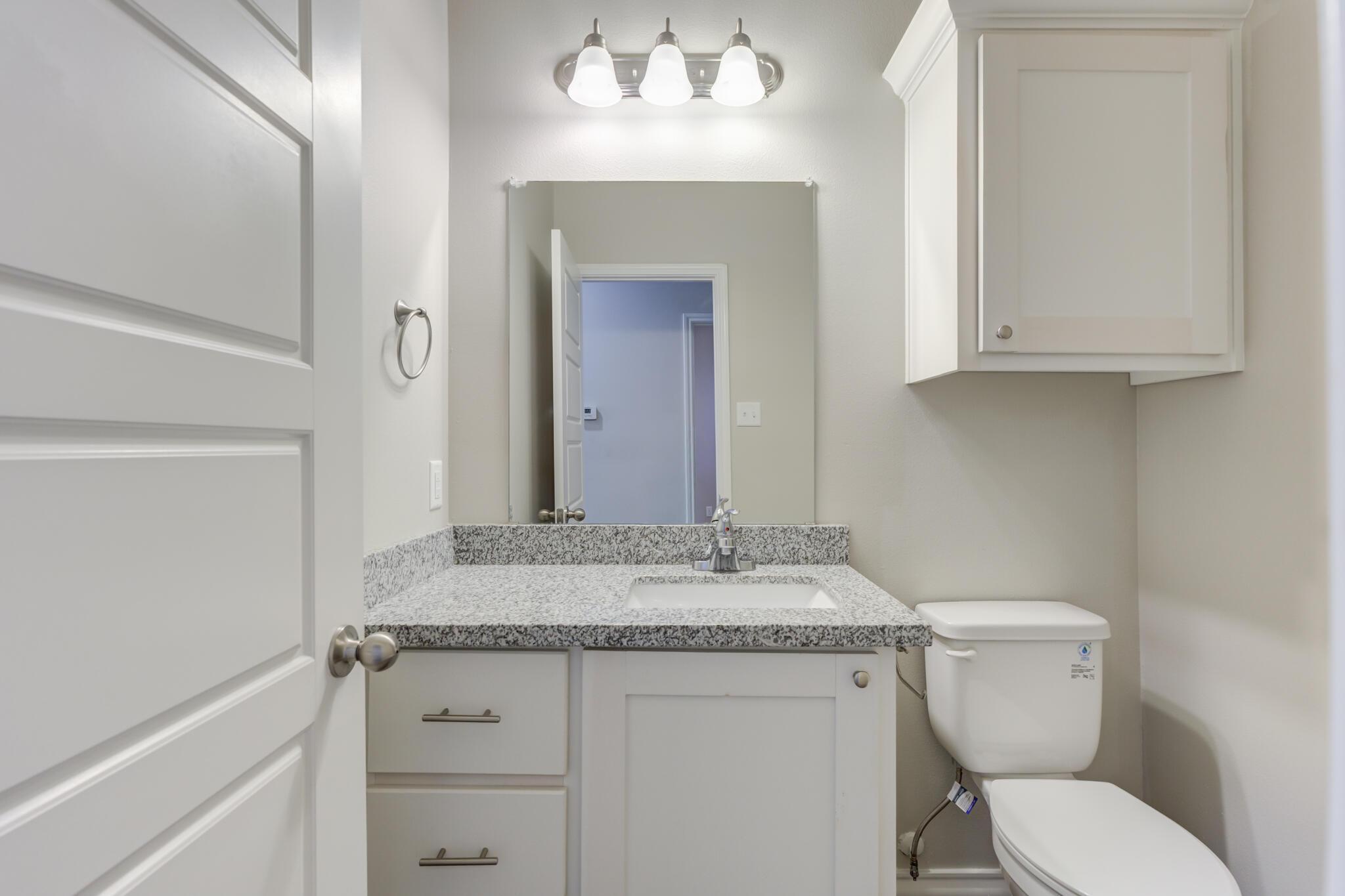 3404 25th Street Lubbock, TX 79410 - Photo 18 of 38 a bathroom with a granite countertop toilet sink and mirror