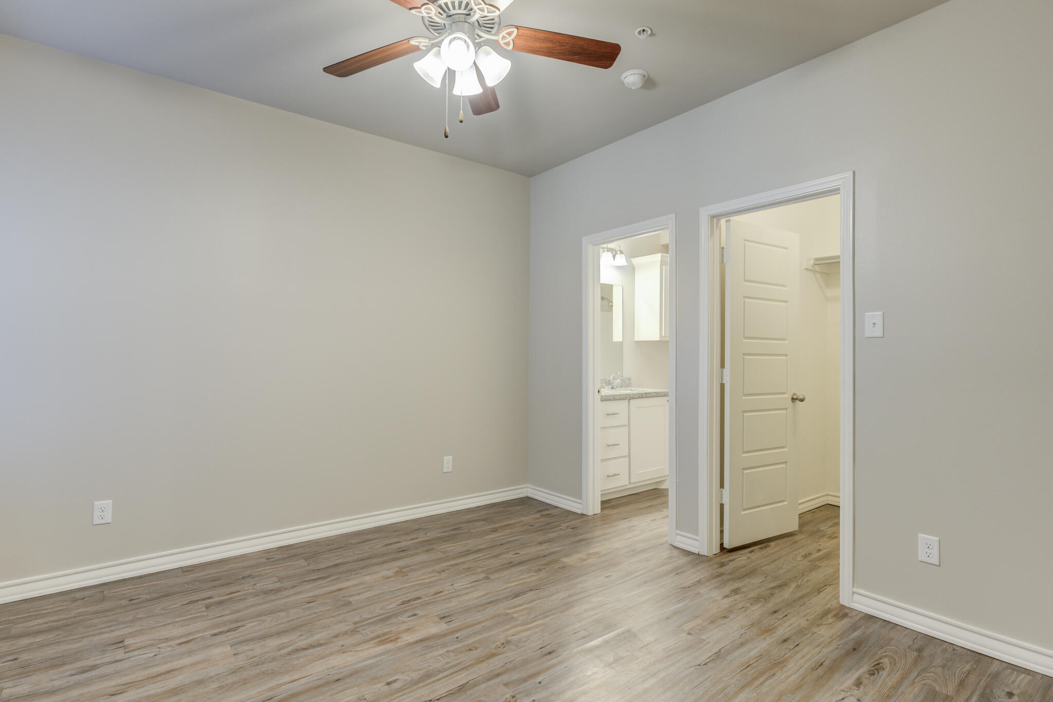 3404 25th Street Lubbock, TX 79410 - Photo 19 of 38 an empty room with wooden floor and a ceiling fan