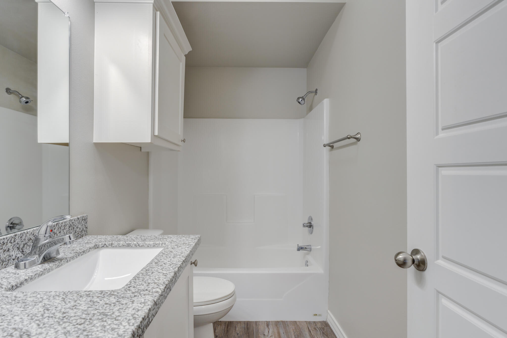3404 25th Street Lubbock, TX 79410 - Photo 22 of 38 a bathroom with a granite countertop sink toilet and shower
