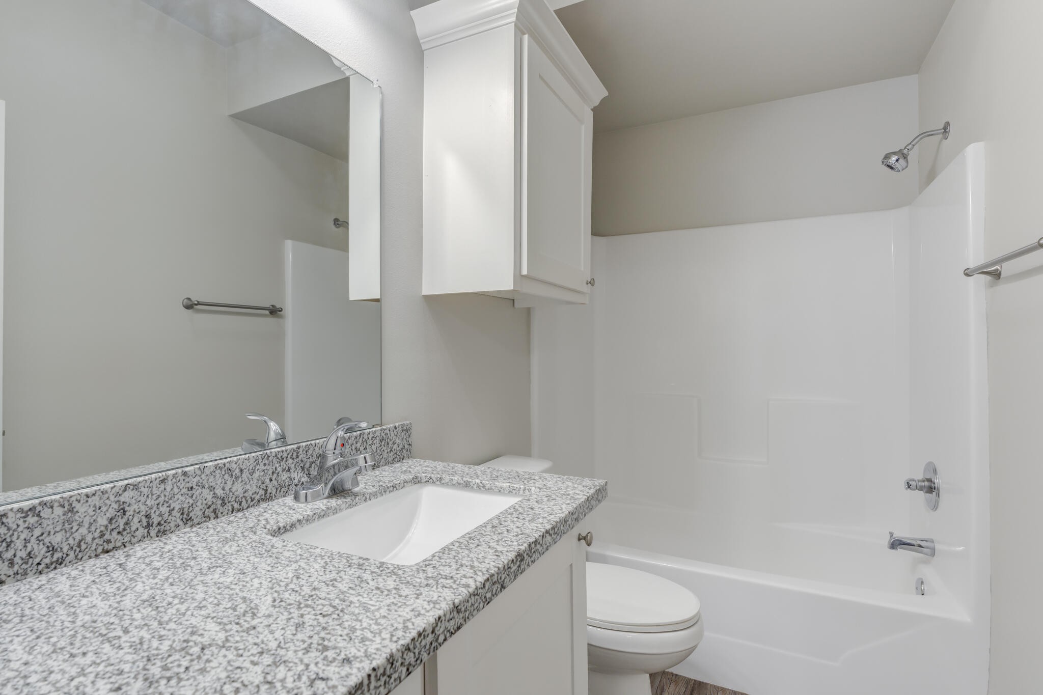 3404 25th Street Lubbock, TX 79410 - Photo 23 of 38 a bathroom with a granite countertop sink toilet and shower