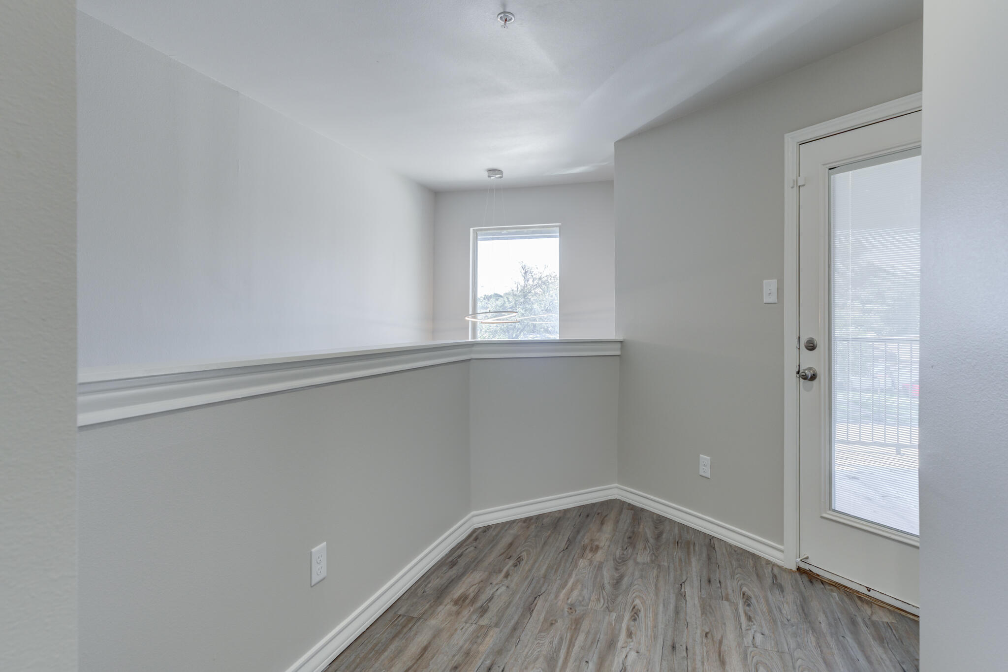 3404 25th Street Lubbock, TX 79410 - Photo 36 of 38 an empty room with wooden floor and windows