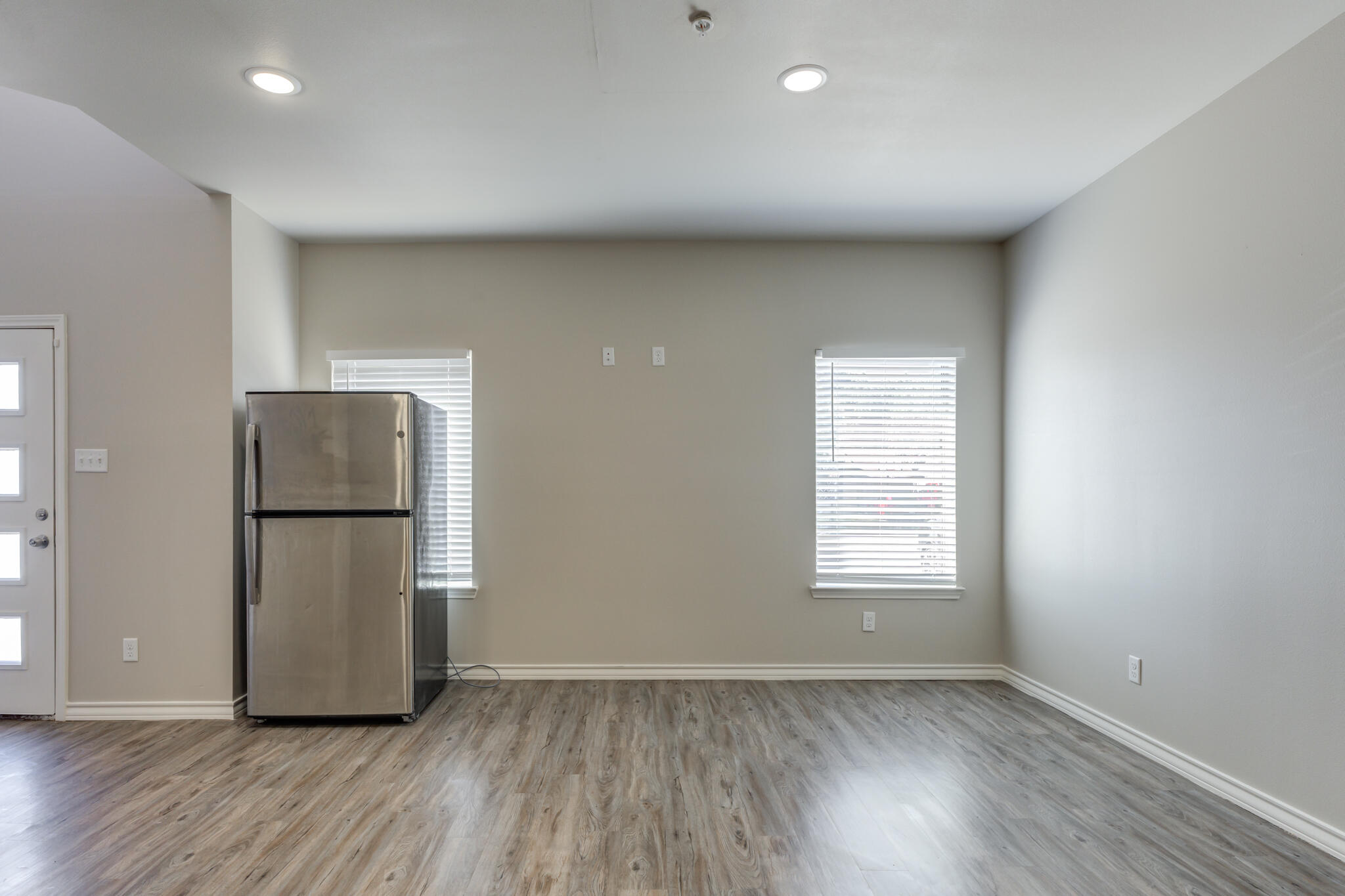 3404 25th Street Lubbock, TX 79410 - Photo 6 of 38 a view of an empty room with wooden floor and a window