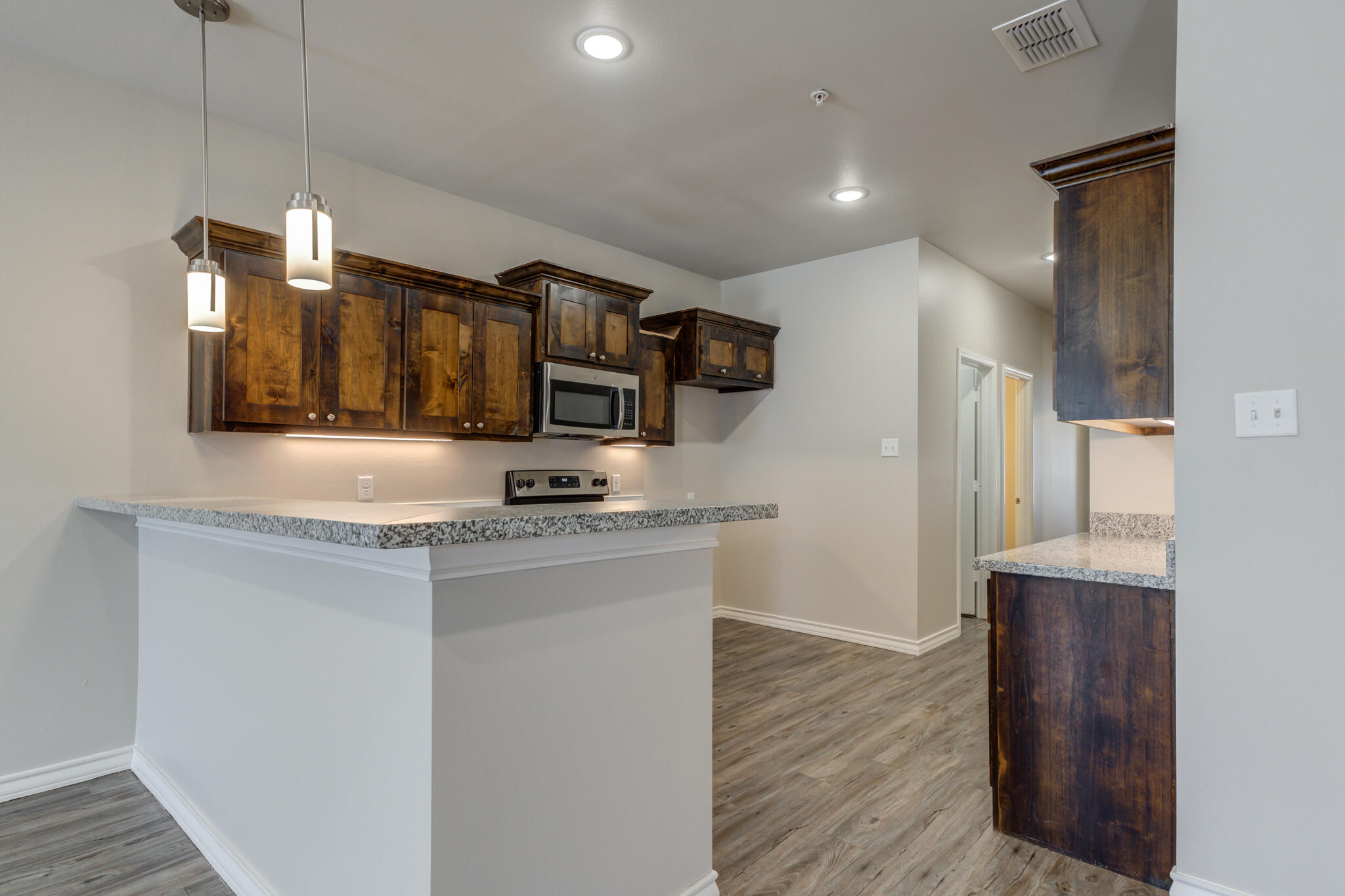 3404 25th Street Lubbock, TX 79410 - Photo 7 of 38 a kitchen with stainless steel appliances granite countertop a sink and refrigerator