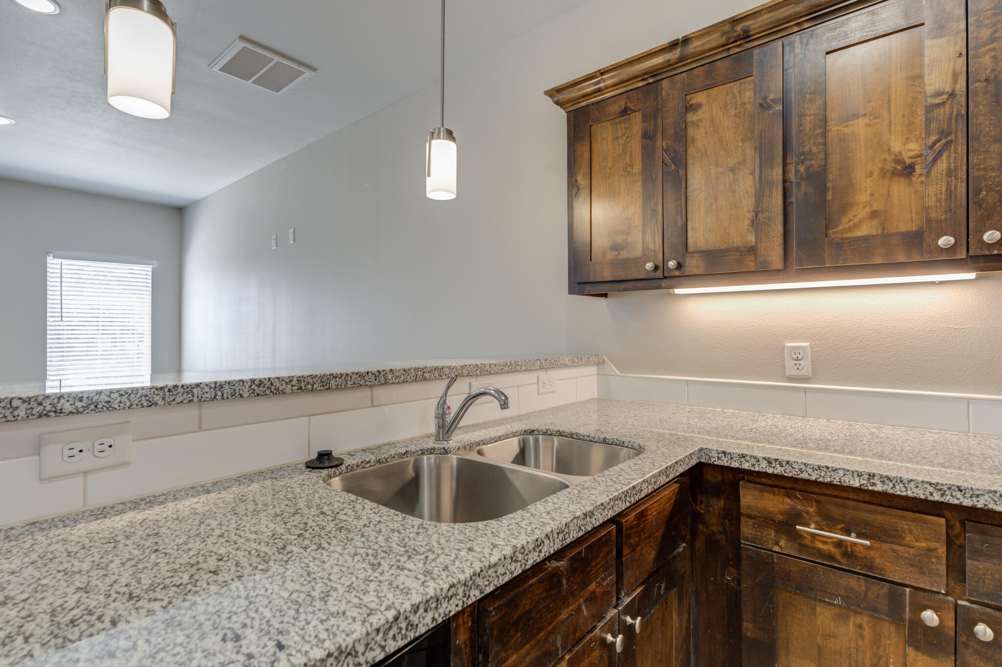 3404 25th Street Lubbock, TX 79410 - Photo 10 of 38 a kitchen with a sink a counter space and cabinets