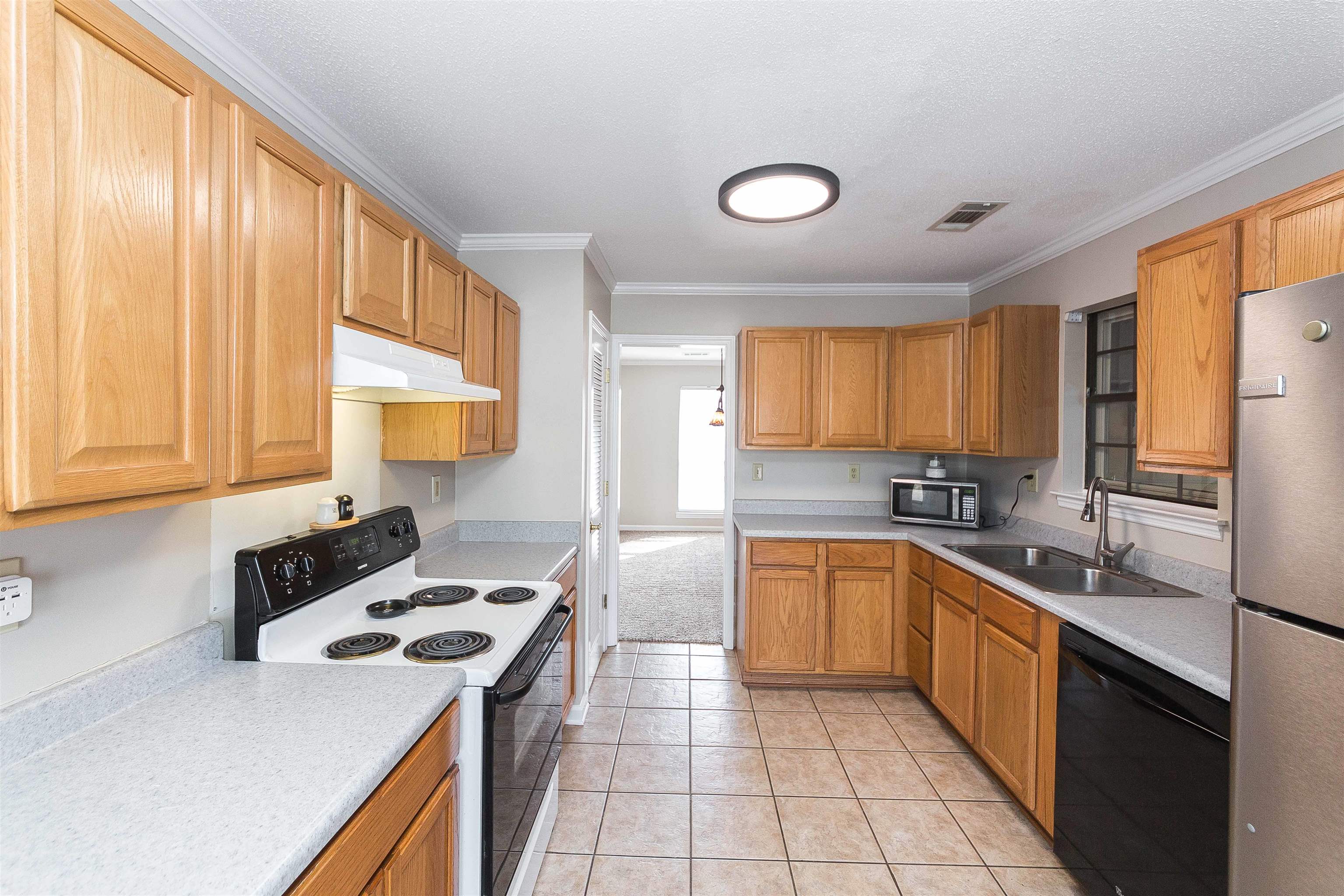 3105 Charles Bryan Road Bartlett, TN 38134 - Photo 16 of 29 a kitchen with a sink stove and cabinets