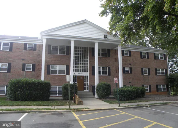 a front view of a house with a garden and garage