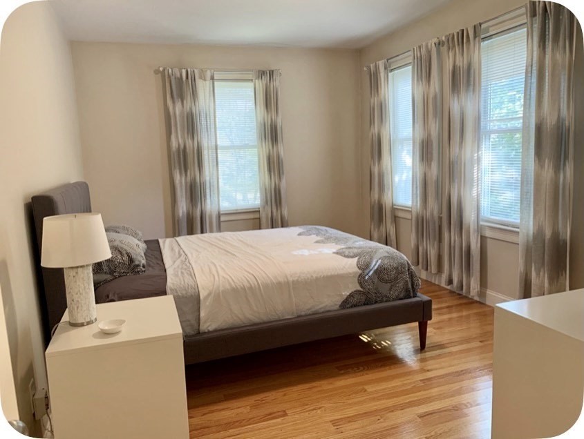 54 Desoto Road, Unit 3 Boston, MA 02132 - Photo 3 of 5 a bedroom with a bed and a mirror