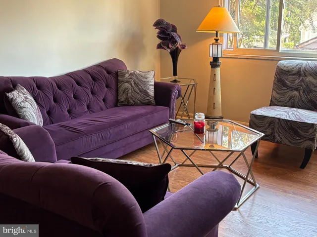 a living room with furniture a dining table and a chandelier