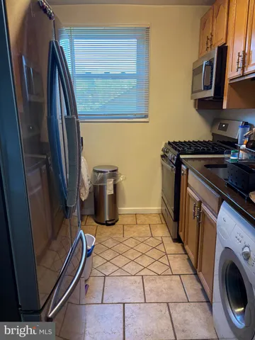a kitchen with a sink a stove top oven and cabinets
