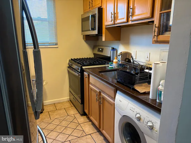 a kitchen with a stove and a refrigerator