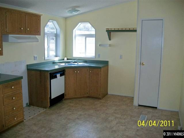 1085 Chisholm Trail Reno, NV 89506 - Photo 4 of 13 a view of a kitchen with granite countertop a sink and a stove
