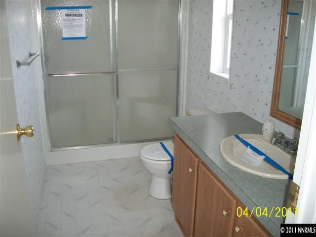 1085 Chisholm Trail Reno, NV 89506 - Photo 7 of 13 a bathroom with a granite countertop toilet a sink and shower