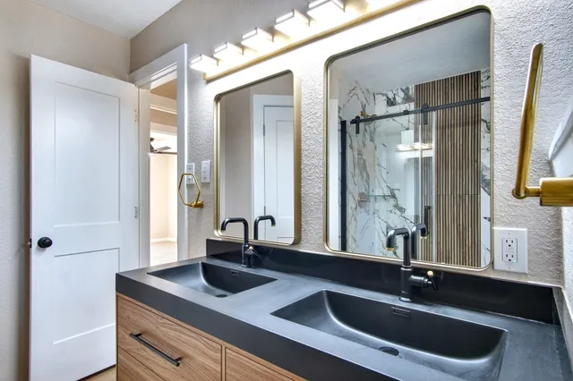 a bathroom with a shower and a glass door